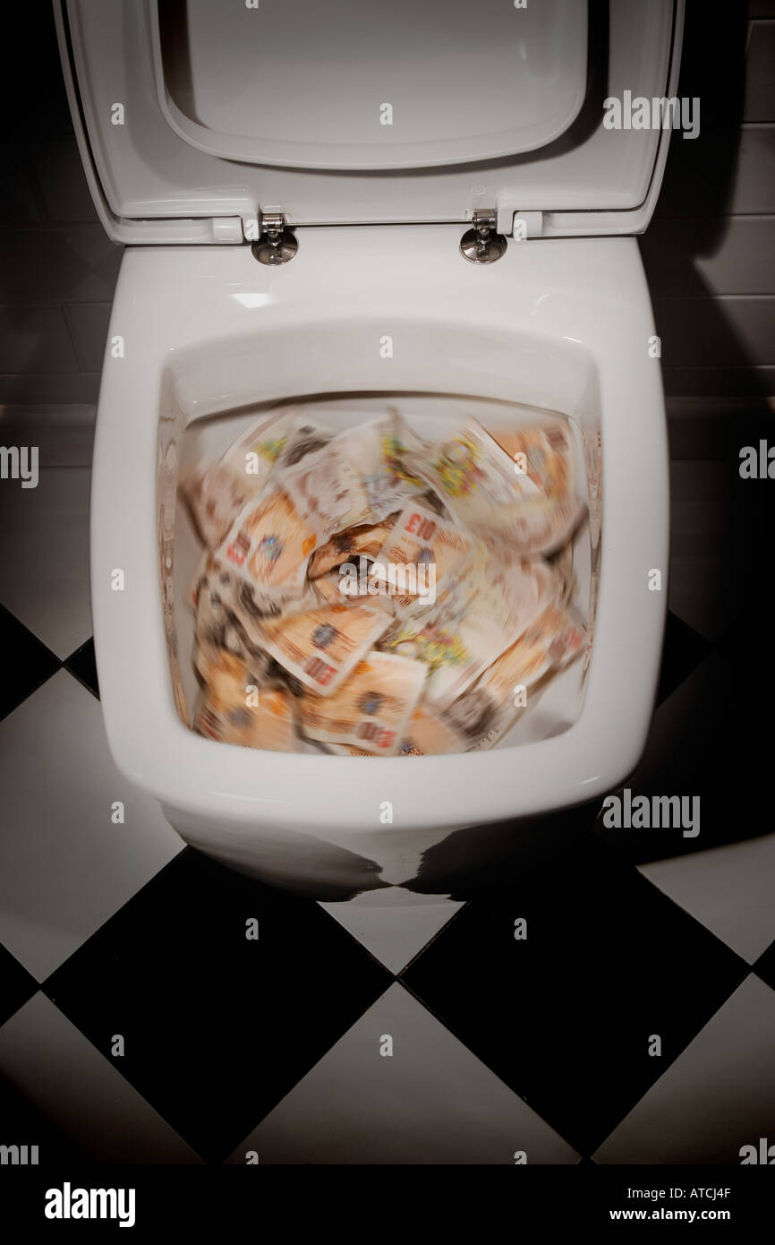 Pound notes being flushed down a toilet Stock Photo Alamy