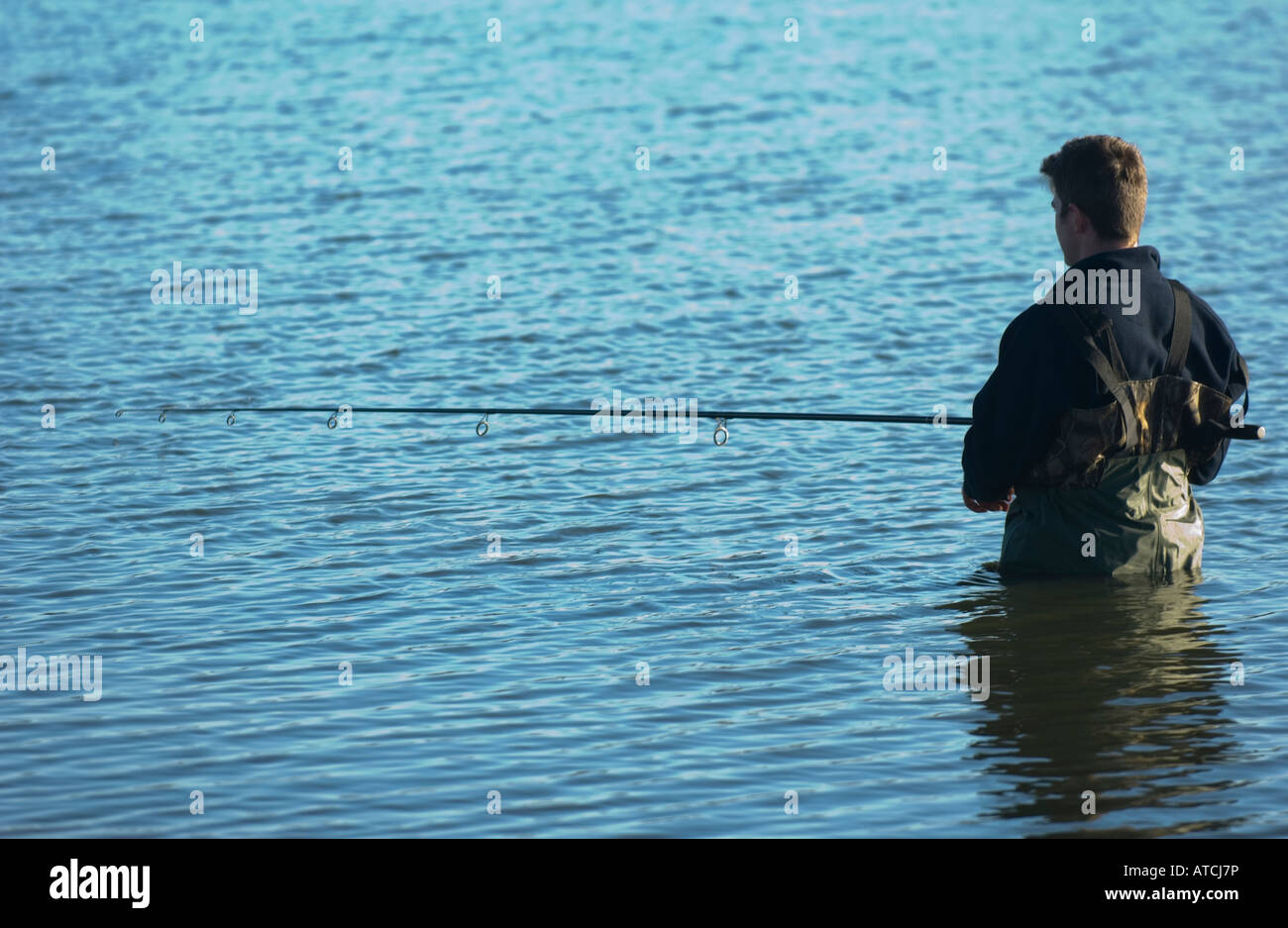 Man fishing in waders Stock Photo - Alamy