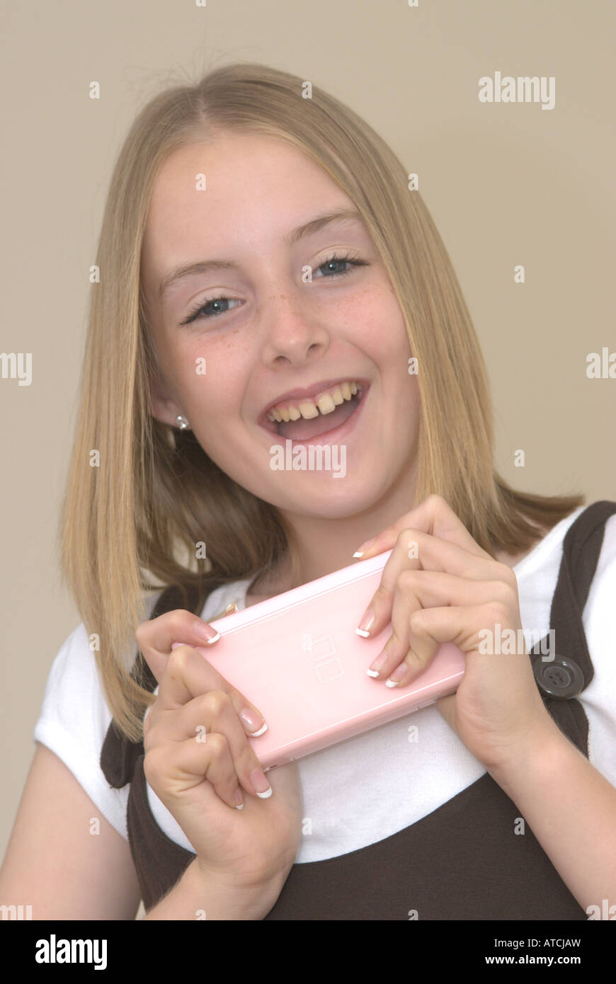 Young girl holding nintendo ds hires stock photography and images Alamy