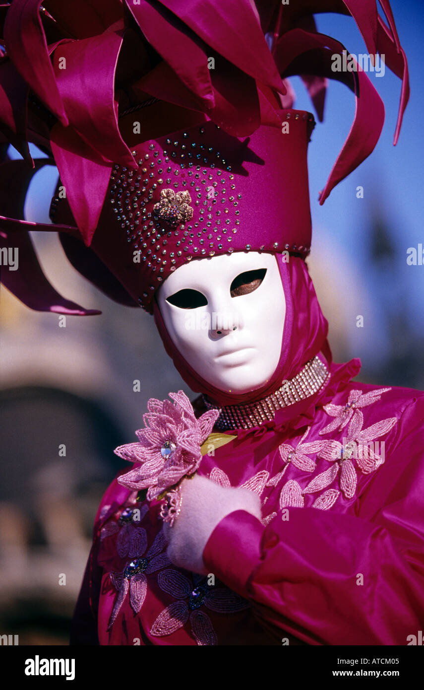 A female masquerader wearing venetian mask and pink costume in Carnival of Venice 2005 Stock Photo
