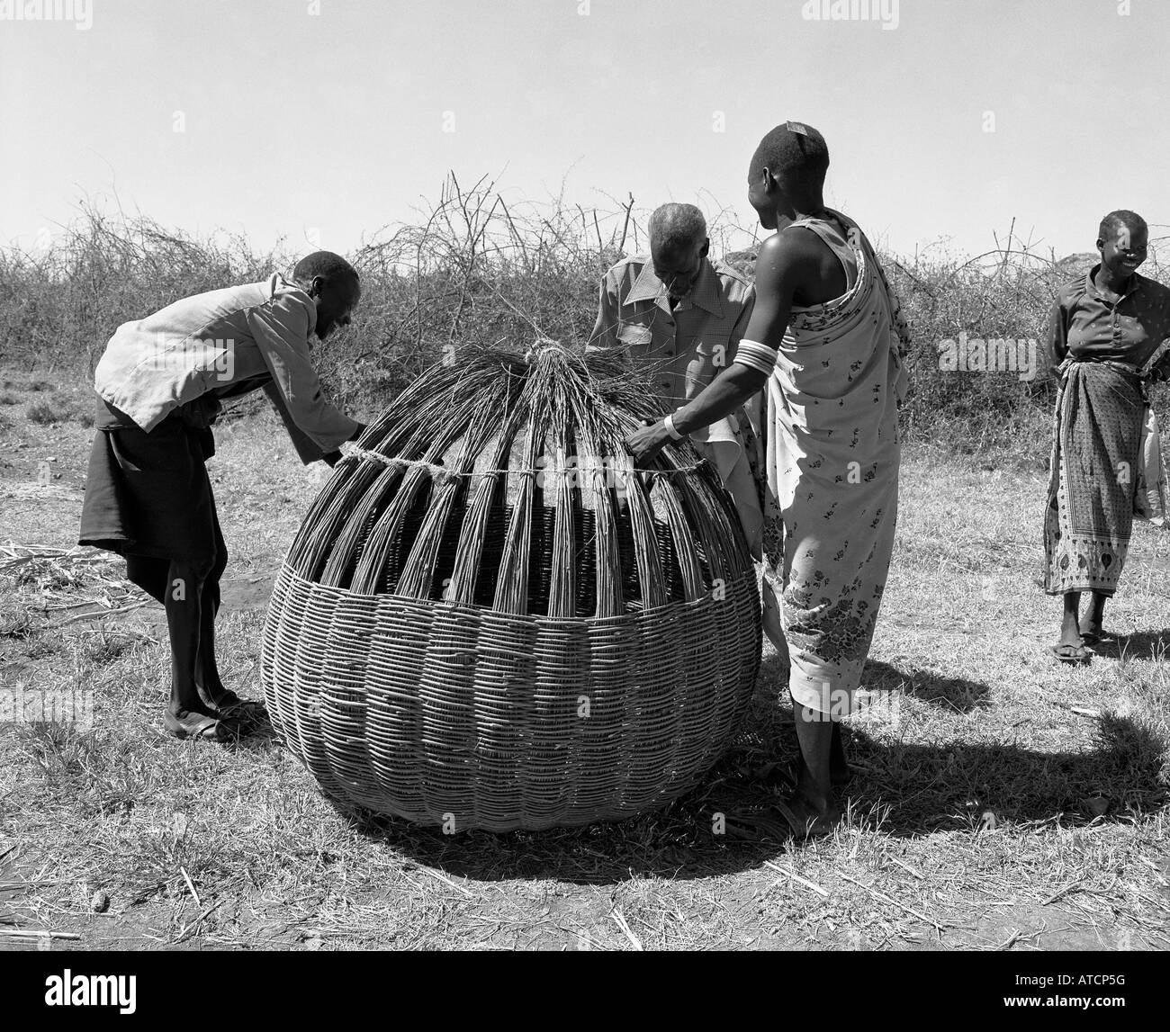 Karamojong warriors making wicker grain bins. Karamoja Uganda Africa Stock Photo Alamy