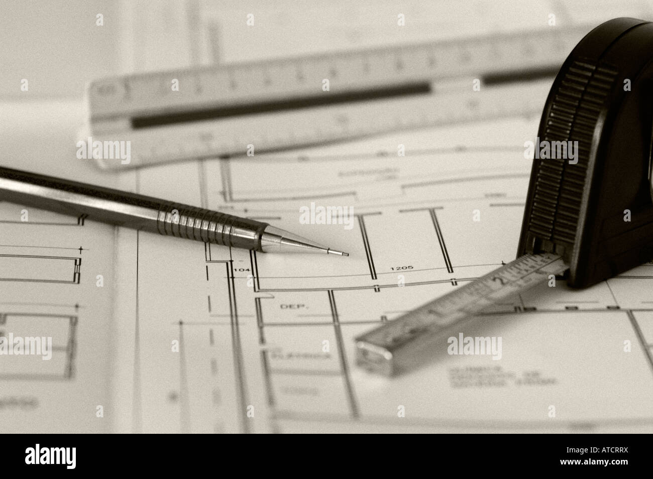 Pencil, triangular scale and tape measure on architecture blueprint