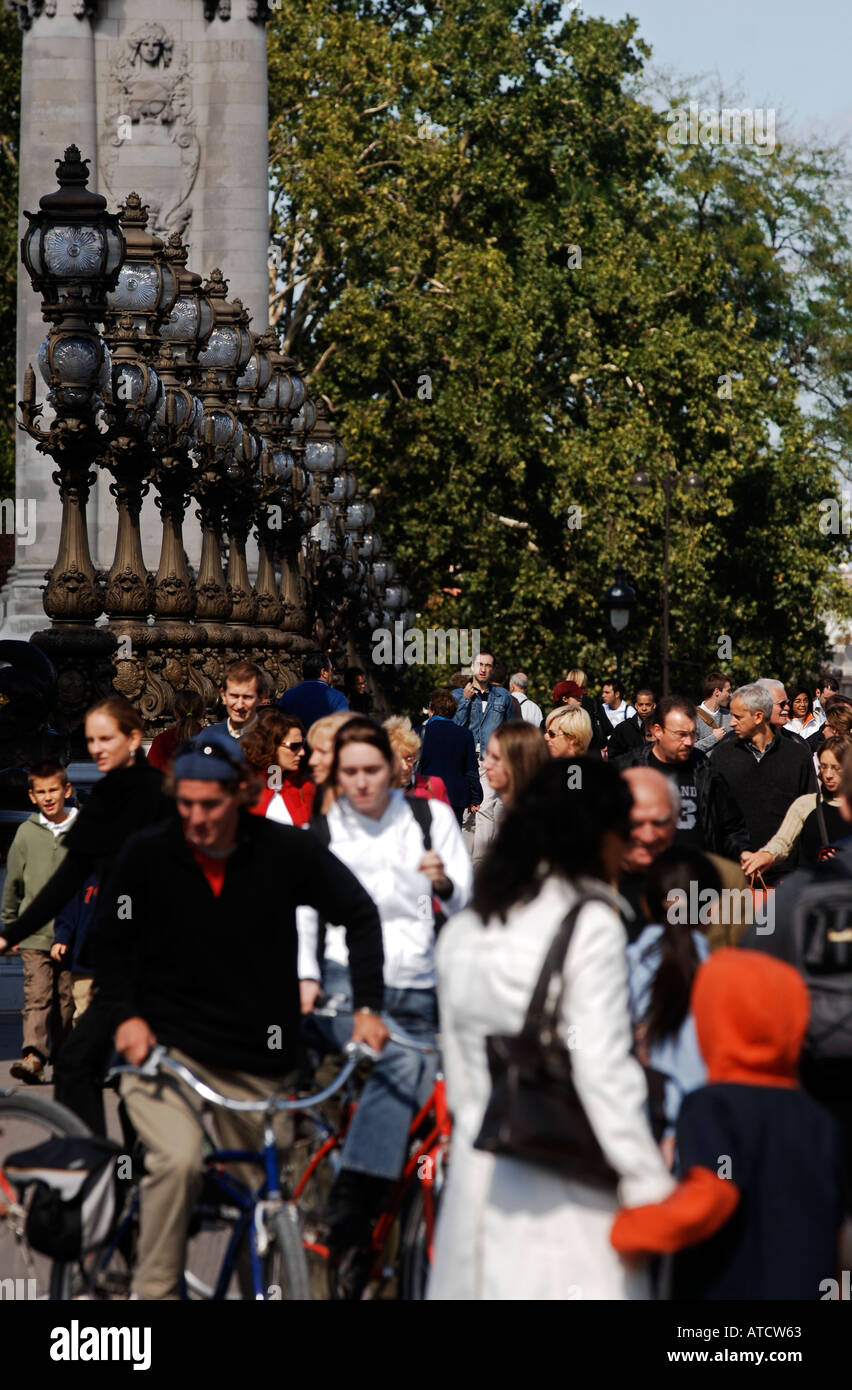 People walking across the Pont Alexandre III Paris France Europe Stock Photo