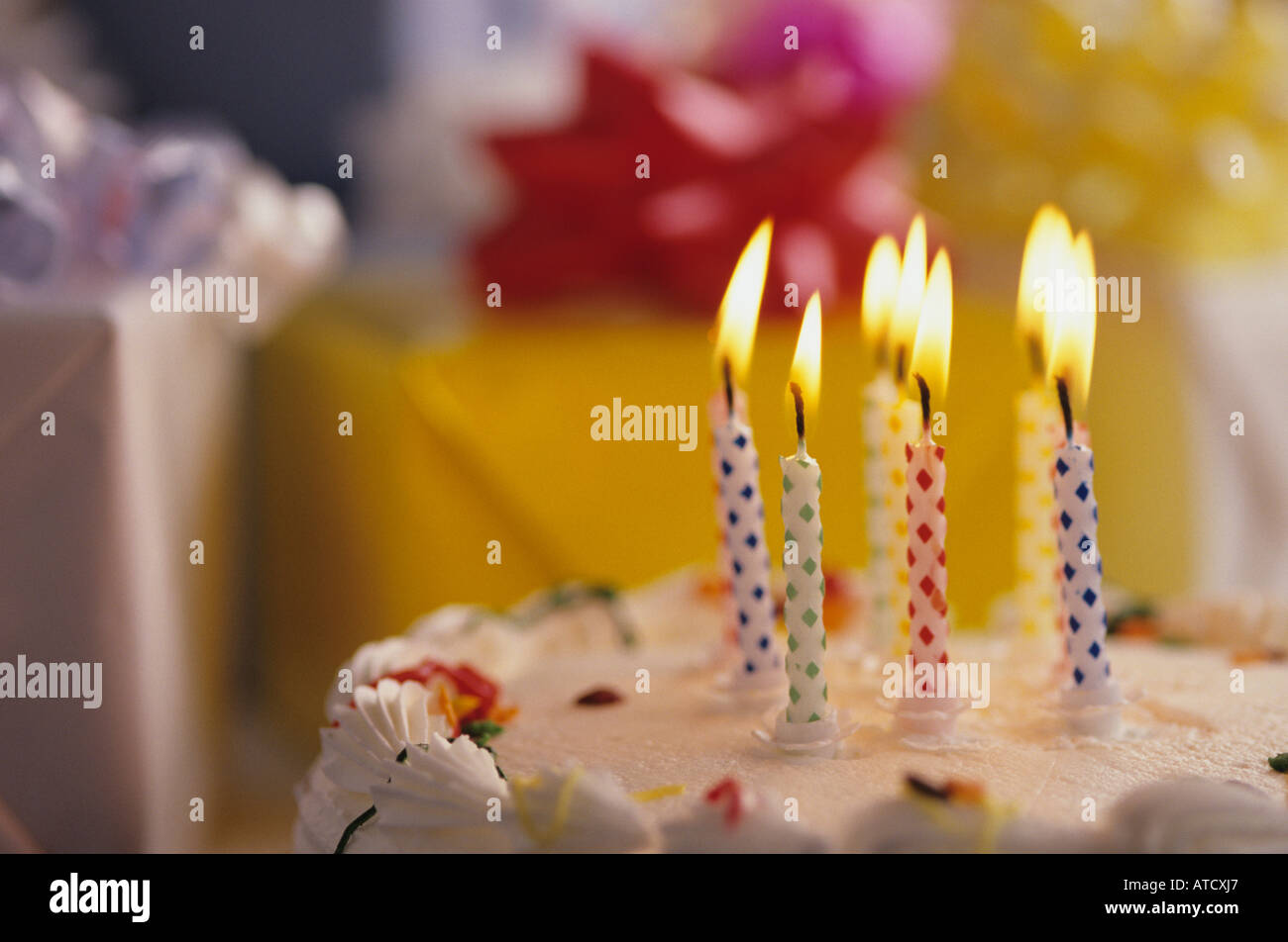 Presents and lit candles on cake, Happy Birthday Celebration Stock