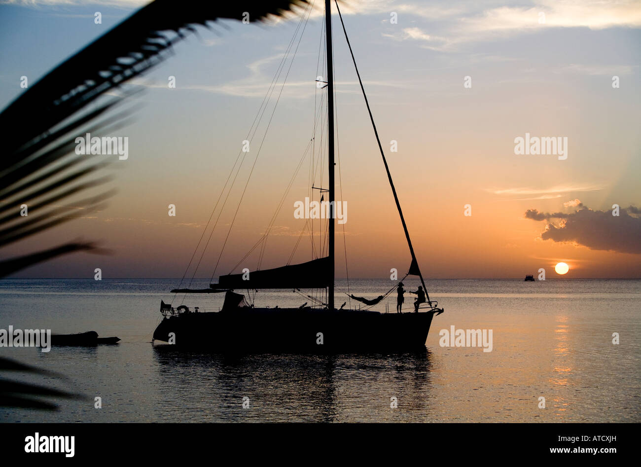 silhouetted boat at sunset Dominca Winward Islands Lesser Antilles British West Indies Stock Photo