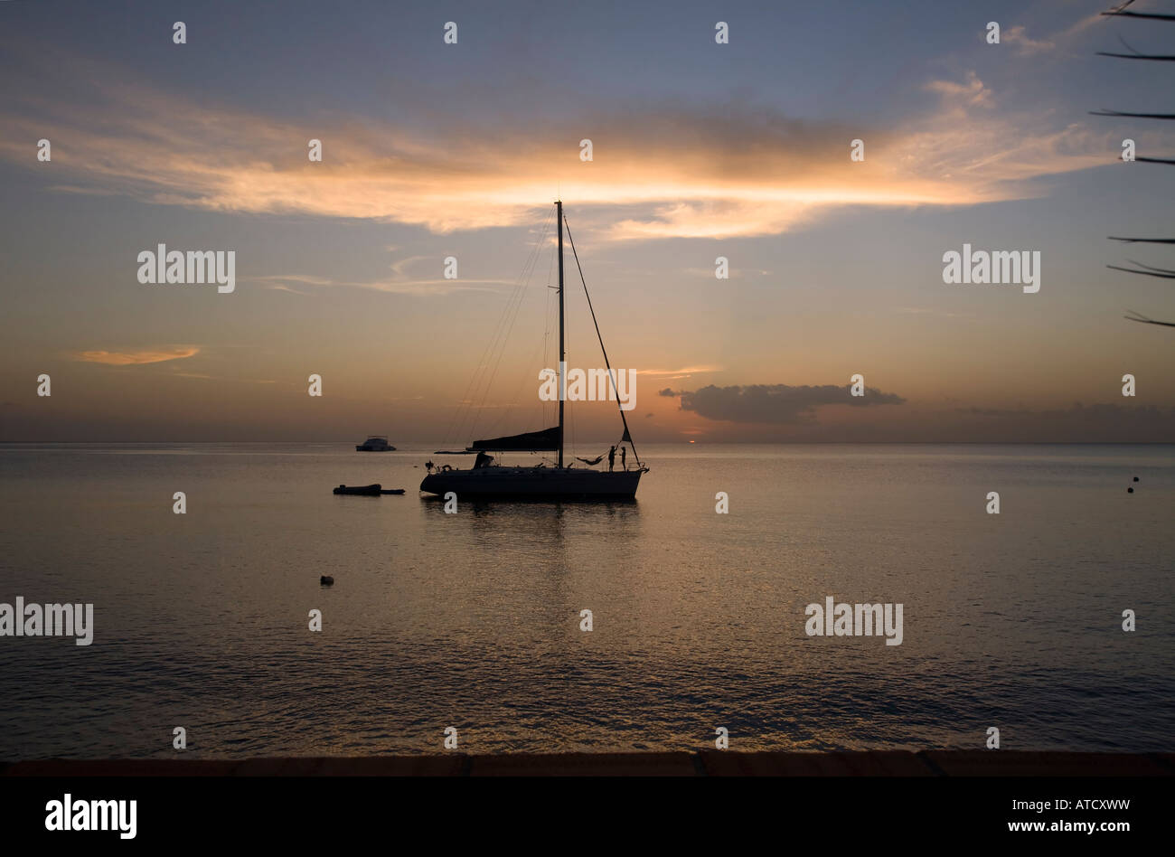 silhouetted boat at sunset Dominca Winward Islands Lesser Antilles British West Indies Stock Photo