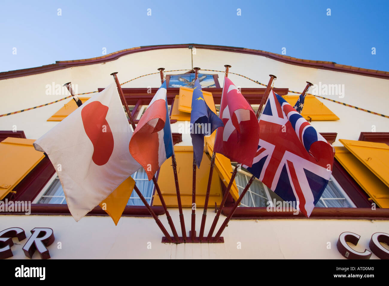 International flags hang from Hotel Cafe Adler in Appenzell Switzerland Stock Photo