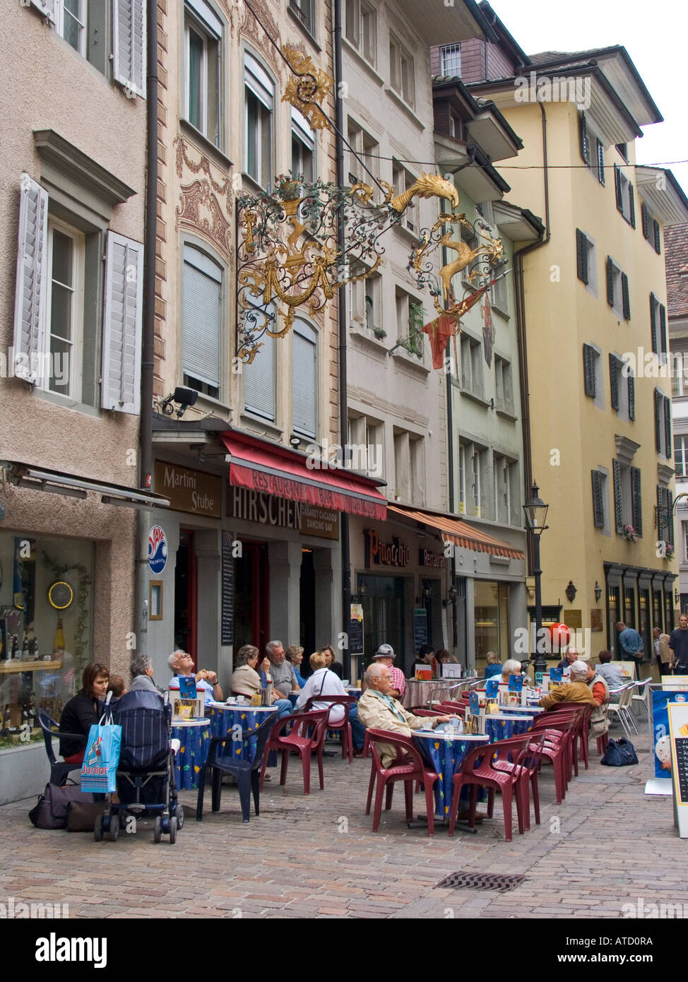 People at outdoor tables in front of the Hirschen Restaurant