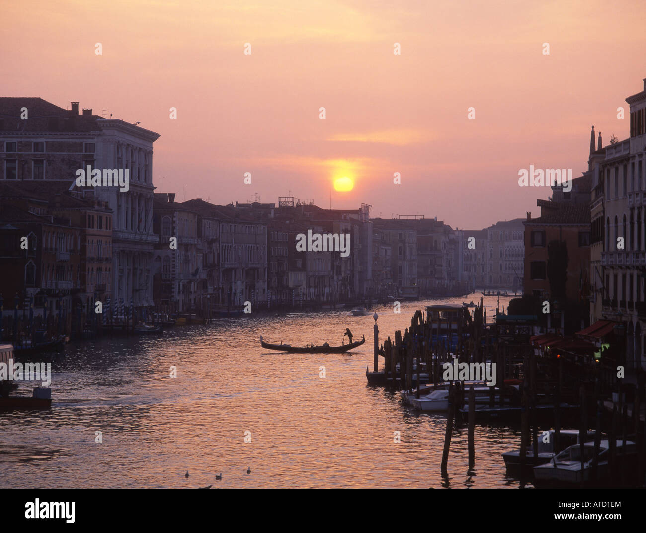 Gondola on Grand Canal at silhouetted at sunset seen from Rialto bridge Venice Veneto Italy Stock Photo
