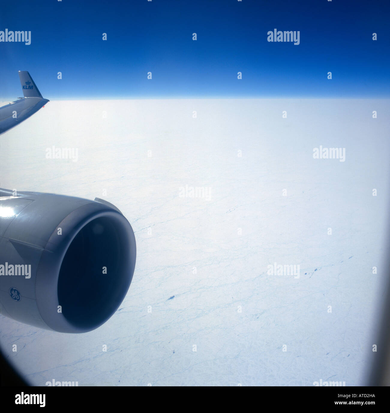 Aerial view of the Canadian Arctic region from window of an airliner with sunlit engine intake and wing tip on left Stock Photo