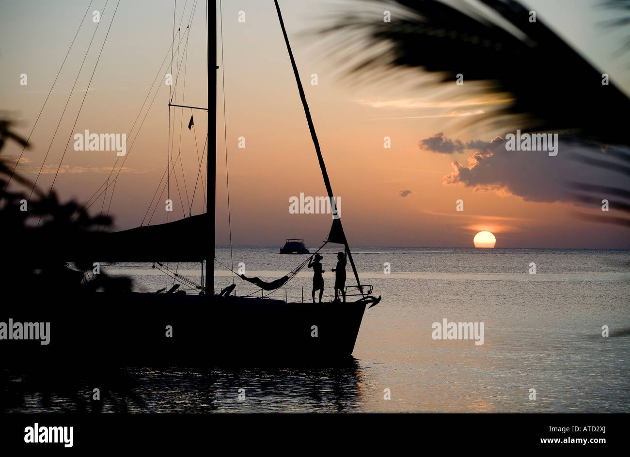 silhouetted boat at sunset Dominca Winward Islands Lesser Antilles British West Indies Stock Photo