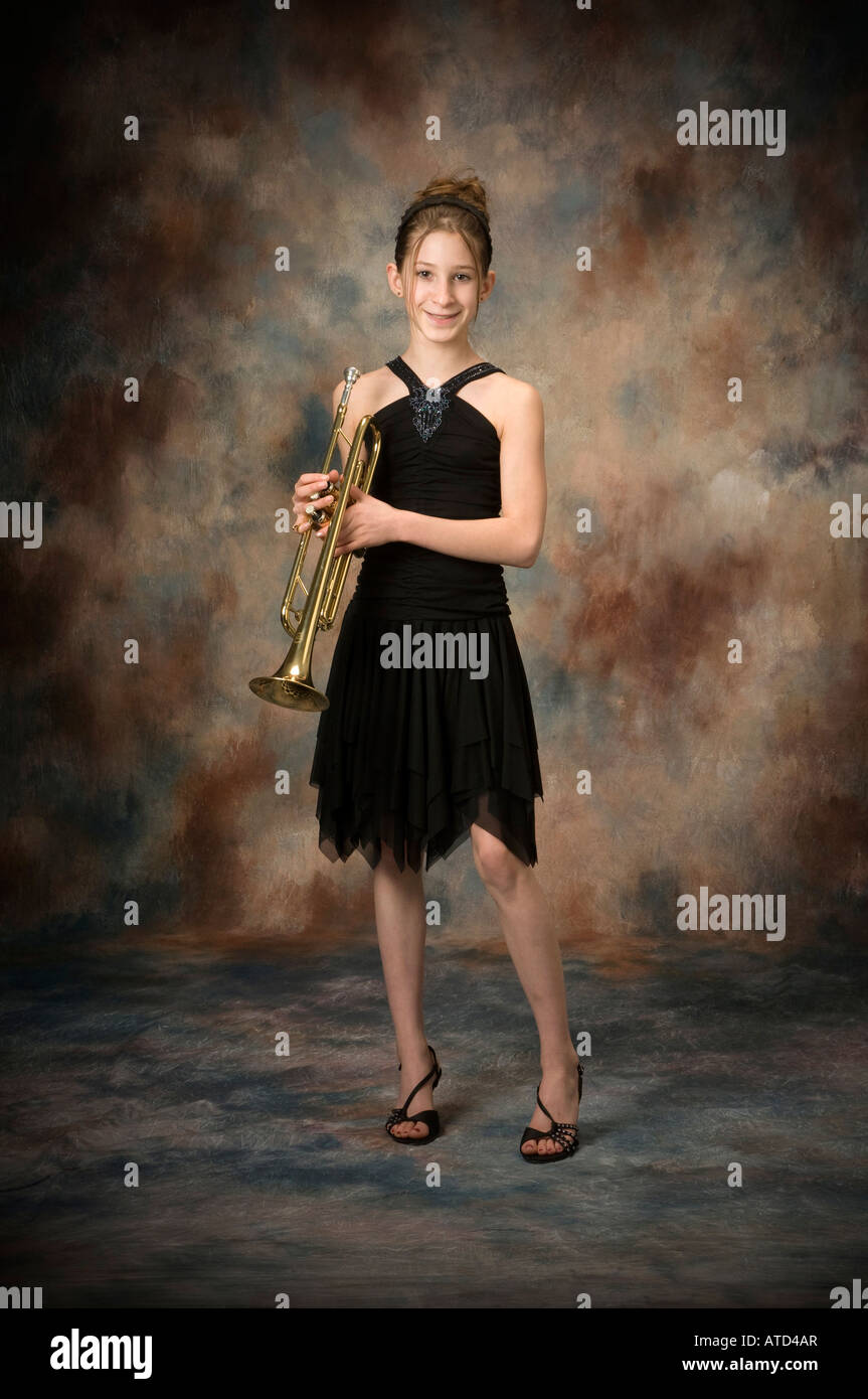 https://c8.alamy.com/comp/ATD4AR/full-body-length-portrait-of-happy-young-teenage-girl-holding-trumpet-ATD4AR.jpg