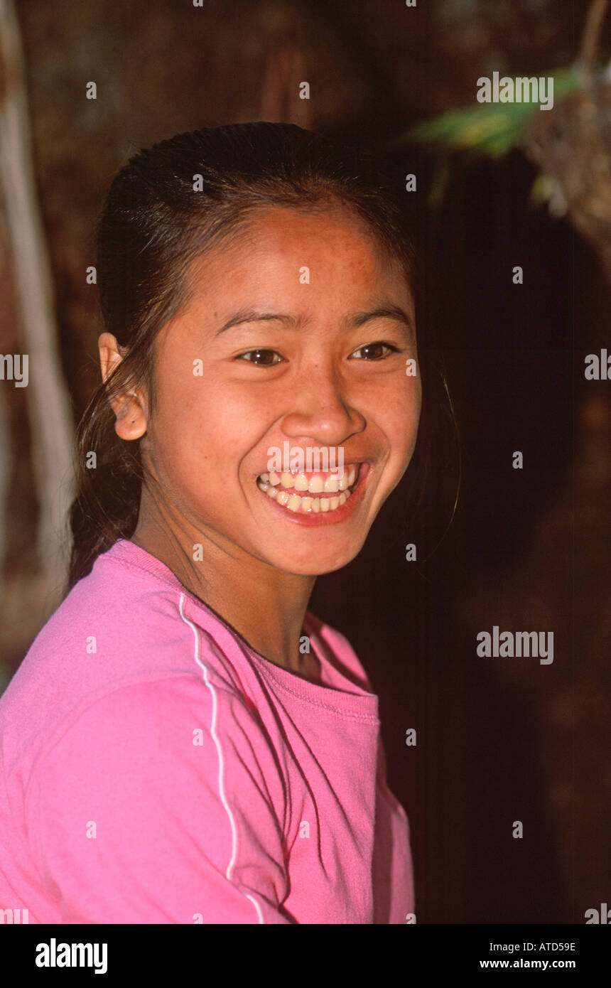 Young loation girl in typical wooden stilt house in remote village in southern Laos Stock Photo