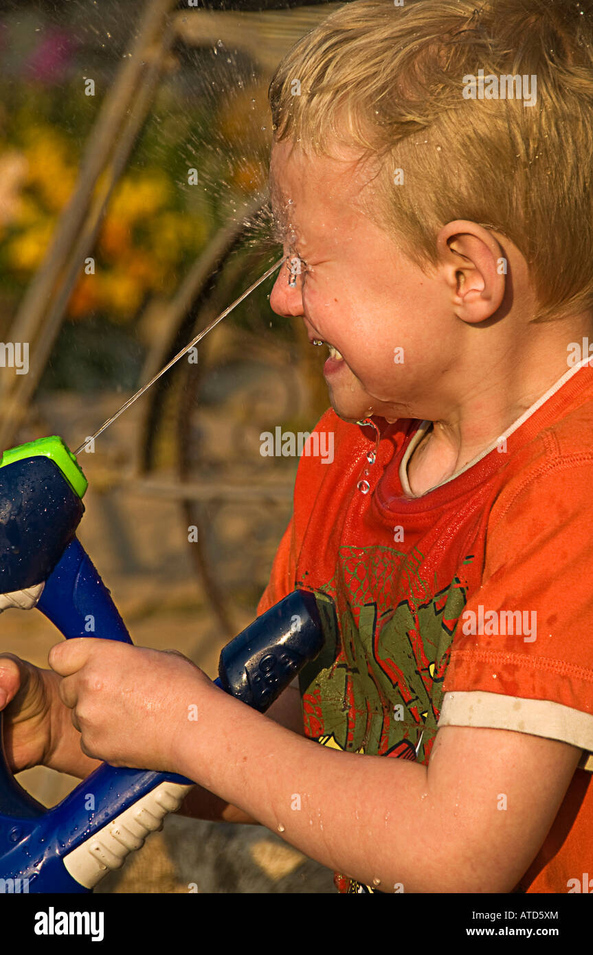 boy squirting face with water Stock Photo - Alamy