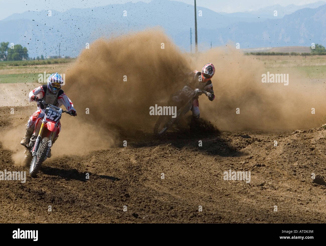 Dirt bikes at motocross track kick up dust Stock Photo
