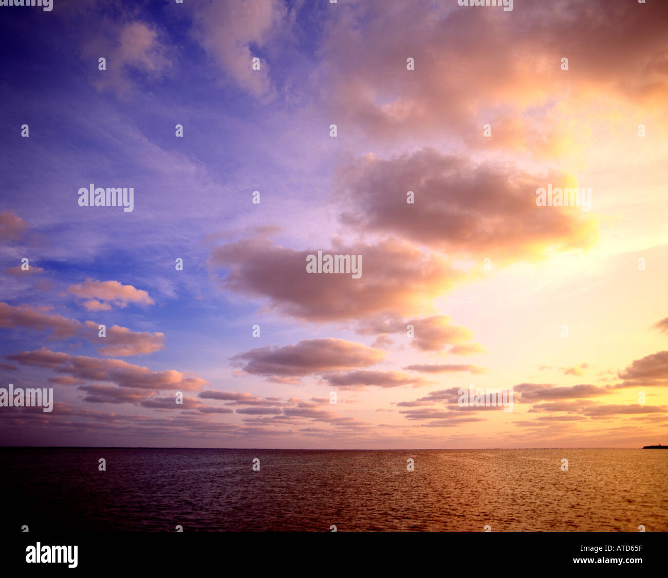 Clouds in a sunset sky over the ocean Stock Photo