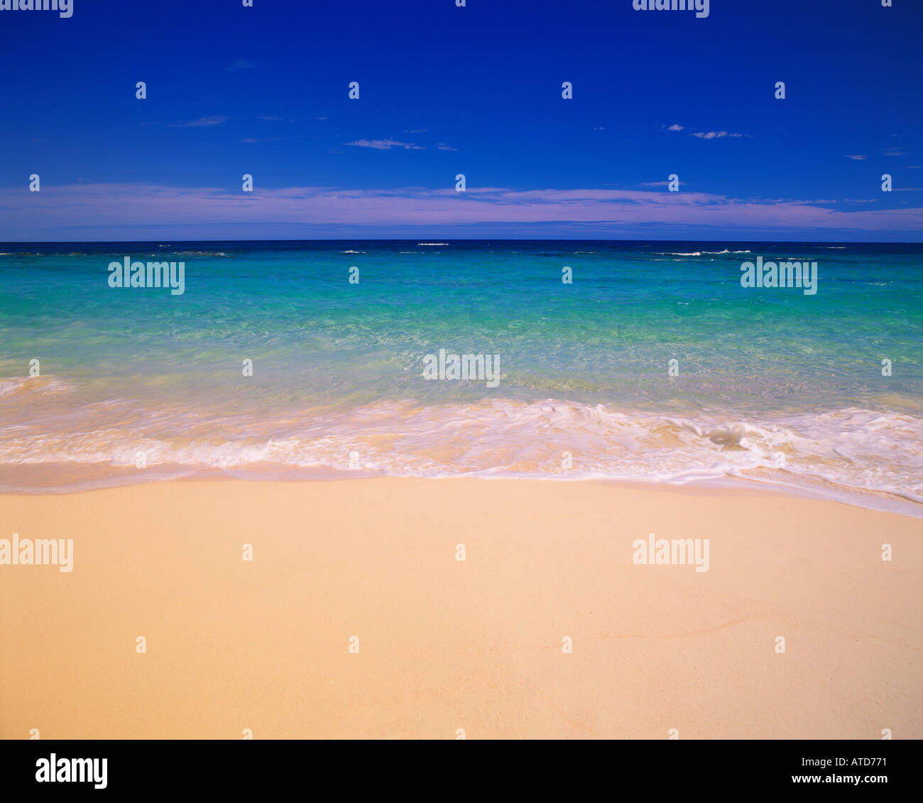 Aqua blue water flows onto the pink sand beaches of the island of Bermuda Stock Photo