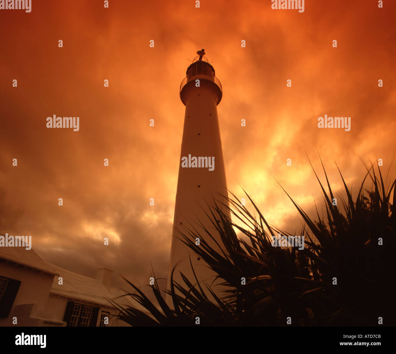 Gibbs Hill Lighthouse against a fiery orange sky at sunset Bermuda Stock Photo