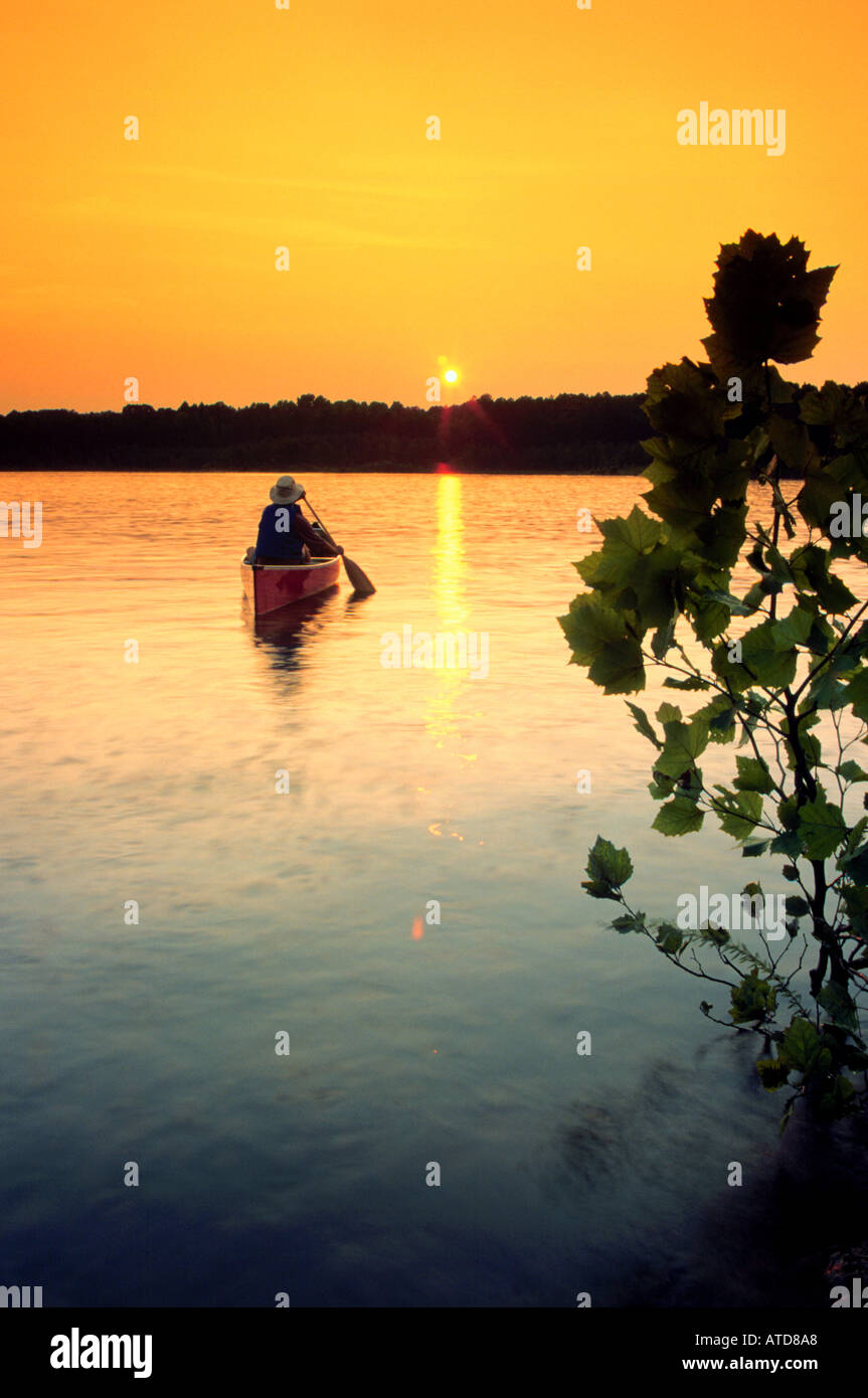 Canoeing on a lake in the heartlands of North Carolina at sunset Stock Photo