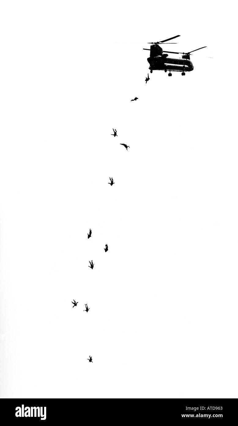 black and white image of skydivers jumping from a military helicopter Stock Photo