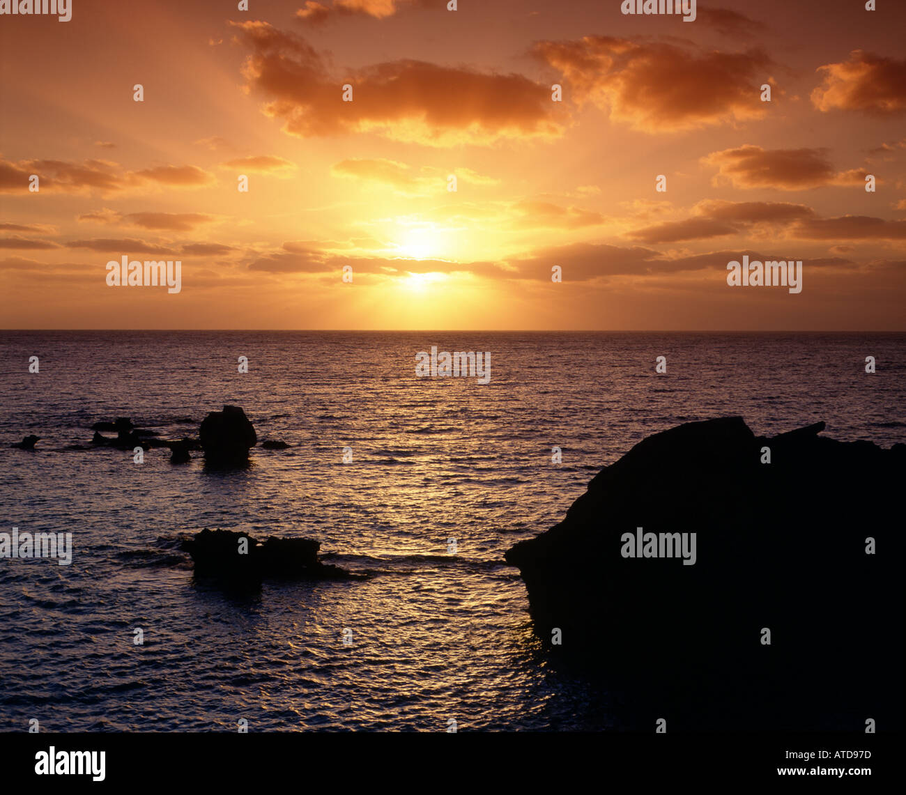 Sunset over rocky coastline hi-res stock photography and images - Alamy