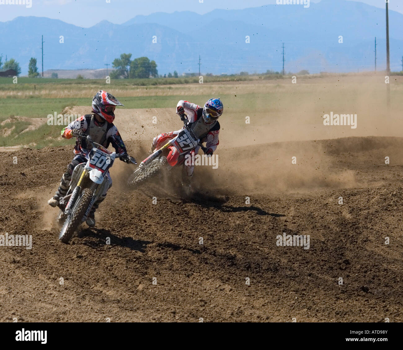Dirt bikes at motocross track much dust Stock Photo