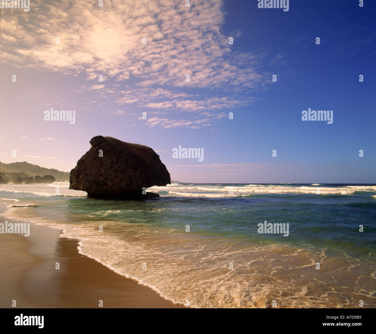 A lone giant boulder sits in the surf at Bathsheba on the east coast of Barbados Stock Photo
