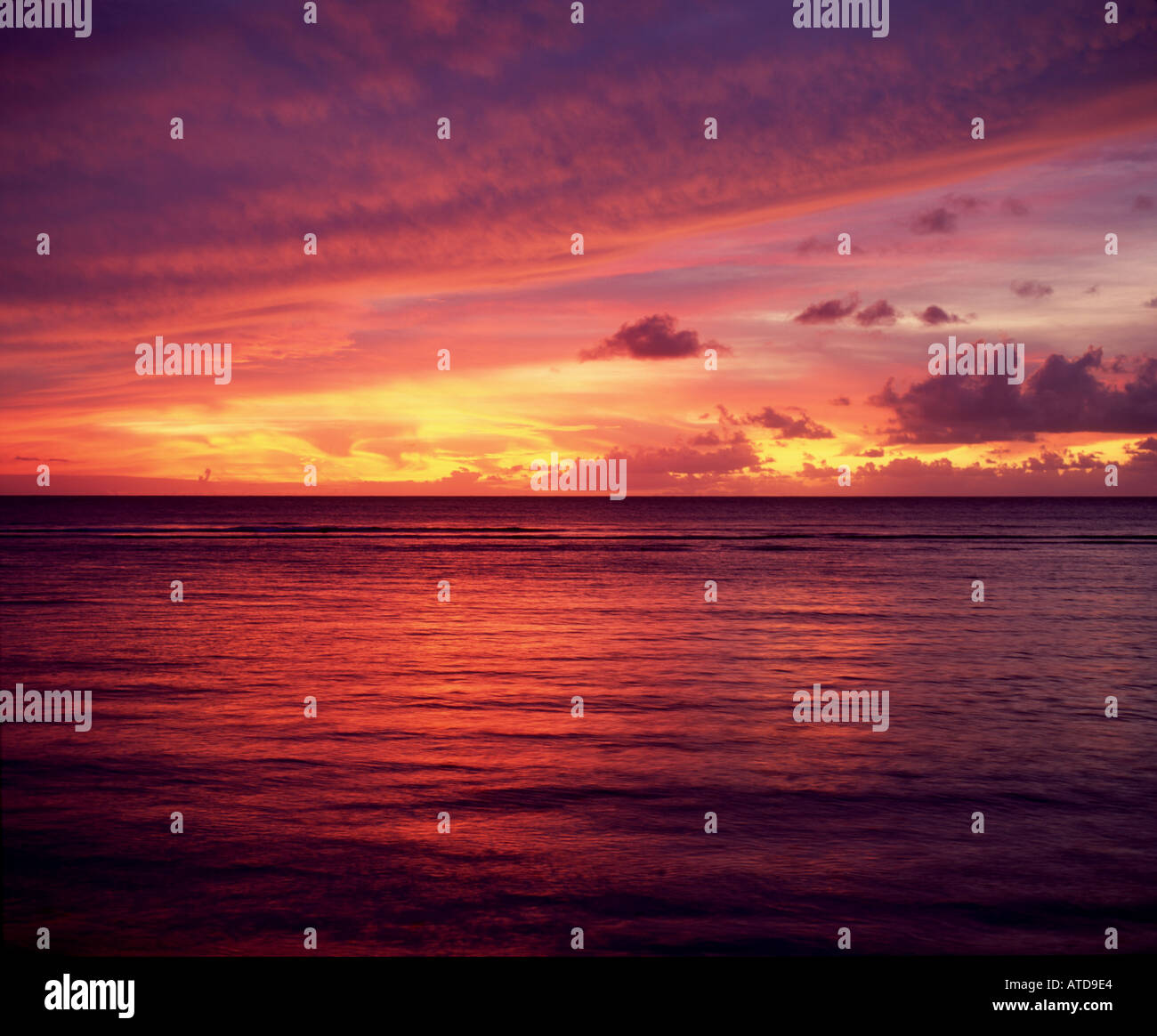 View of a dramatic and colorful sunset over the ocean from the Caribbean island of Tobago Stock Photo