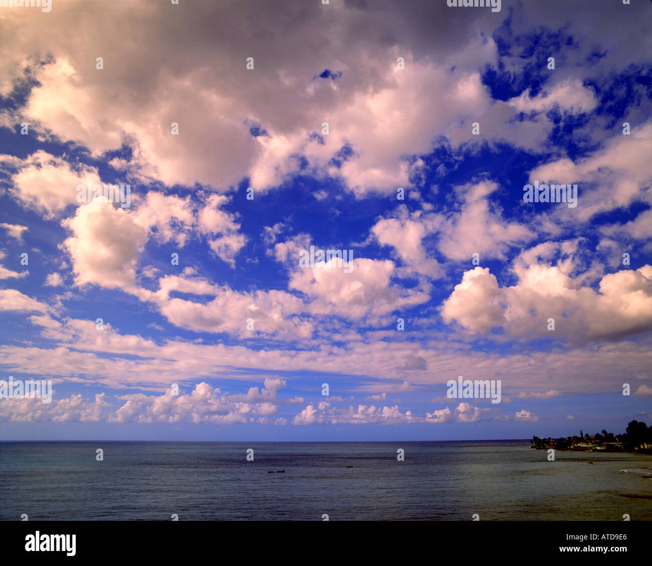 A brilliant blue Caribbean sky full of fluffy white clouds Stock Photo