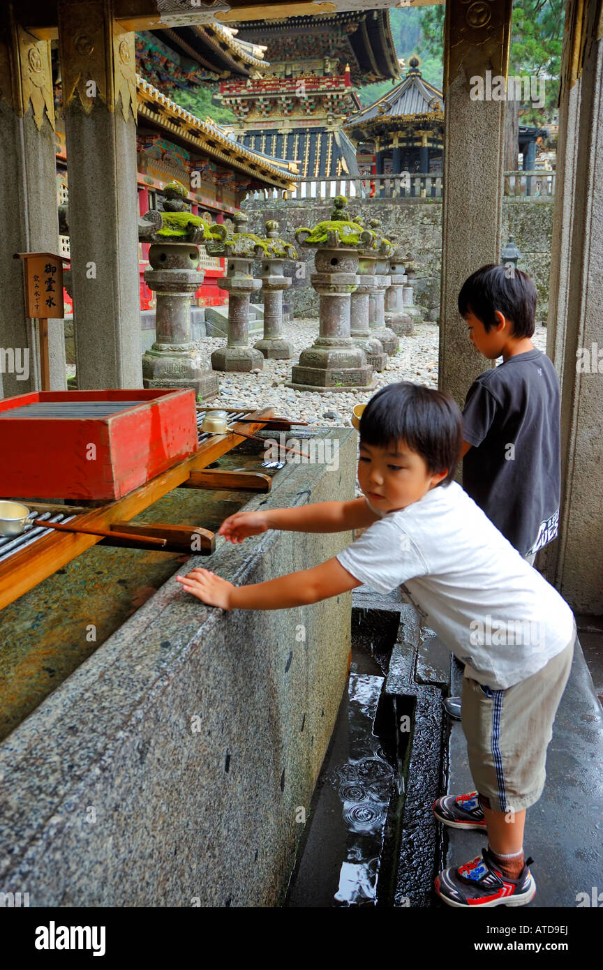 Japanese children washing their hands Nikko Tochigi Japan Japanese UNESCO World Heritage Stock Photo