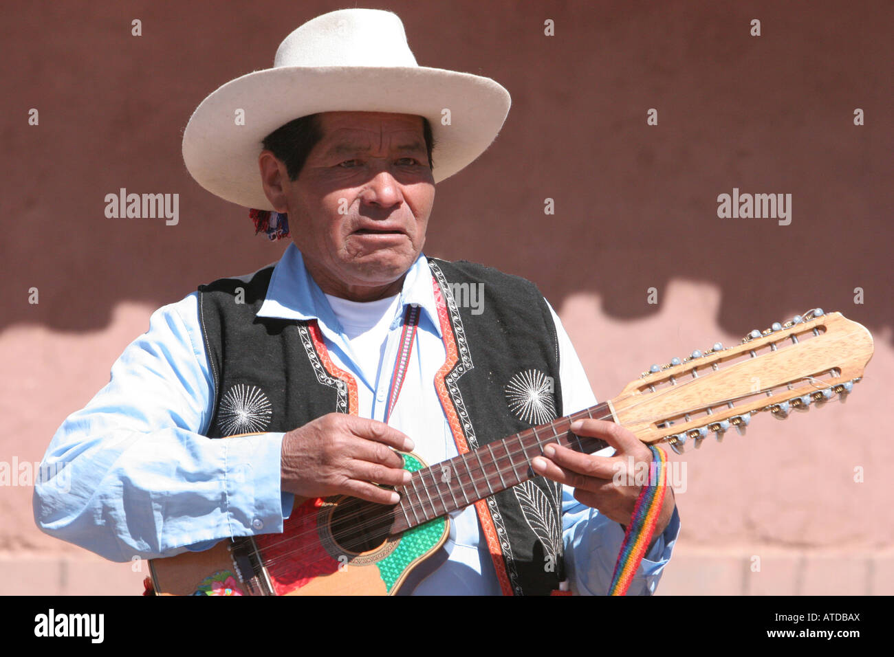 A Peruvian musician plays at a market near the Puno Region of Peru Stock Photo