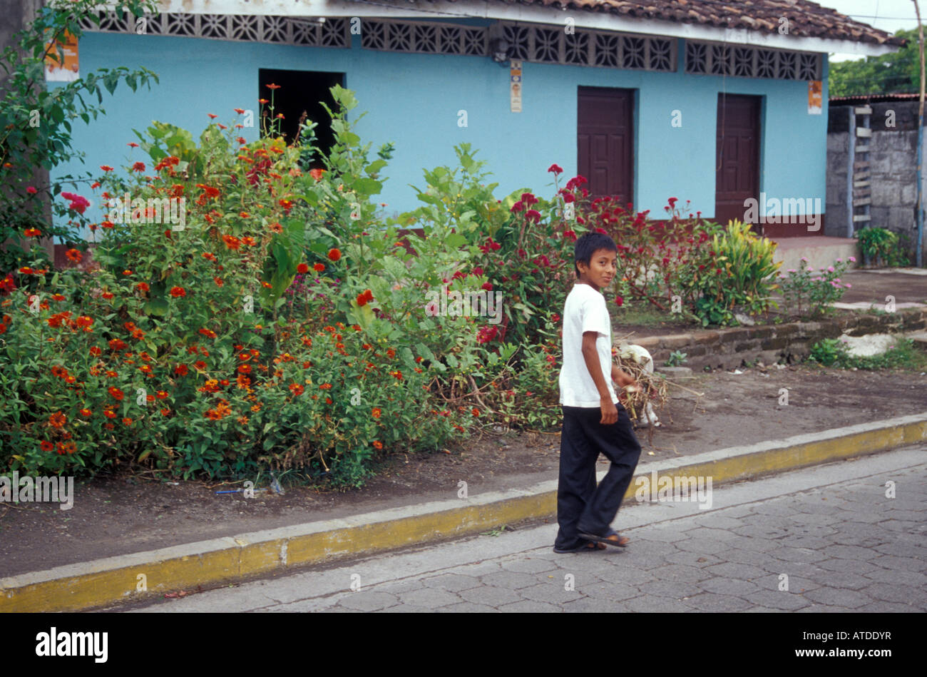 Boy walking down a street in the town of Altagracia on Isla de Ometepe or Ometepe Island Nicaragua Stock Photo