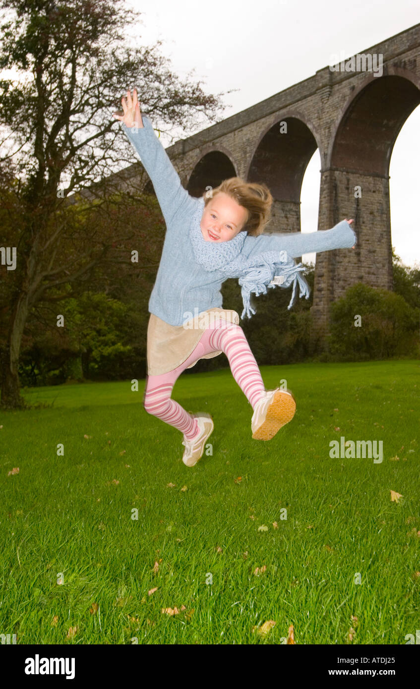 Young girl jumping for joy Stock Photo - Alamy