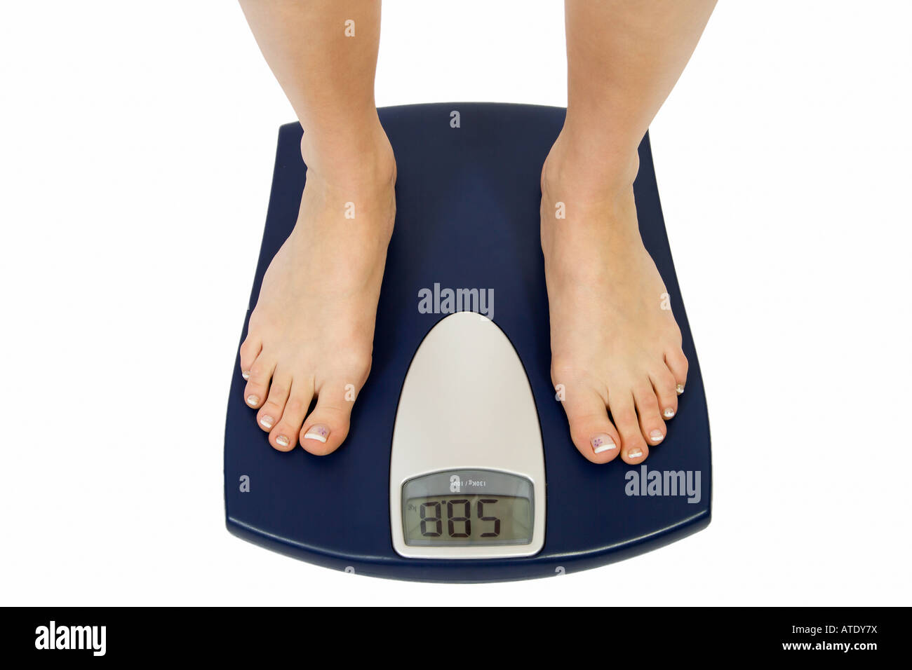 Female feet standing on a bathroom scale Stock Photo Alamy
