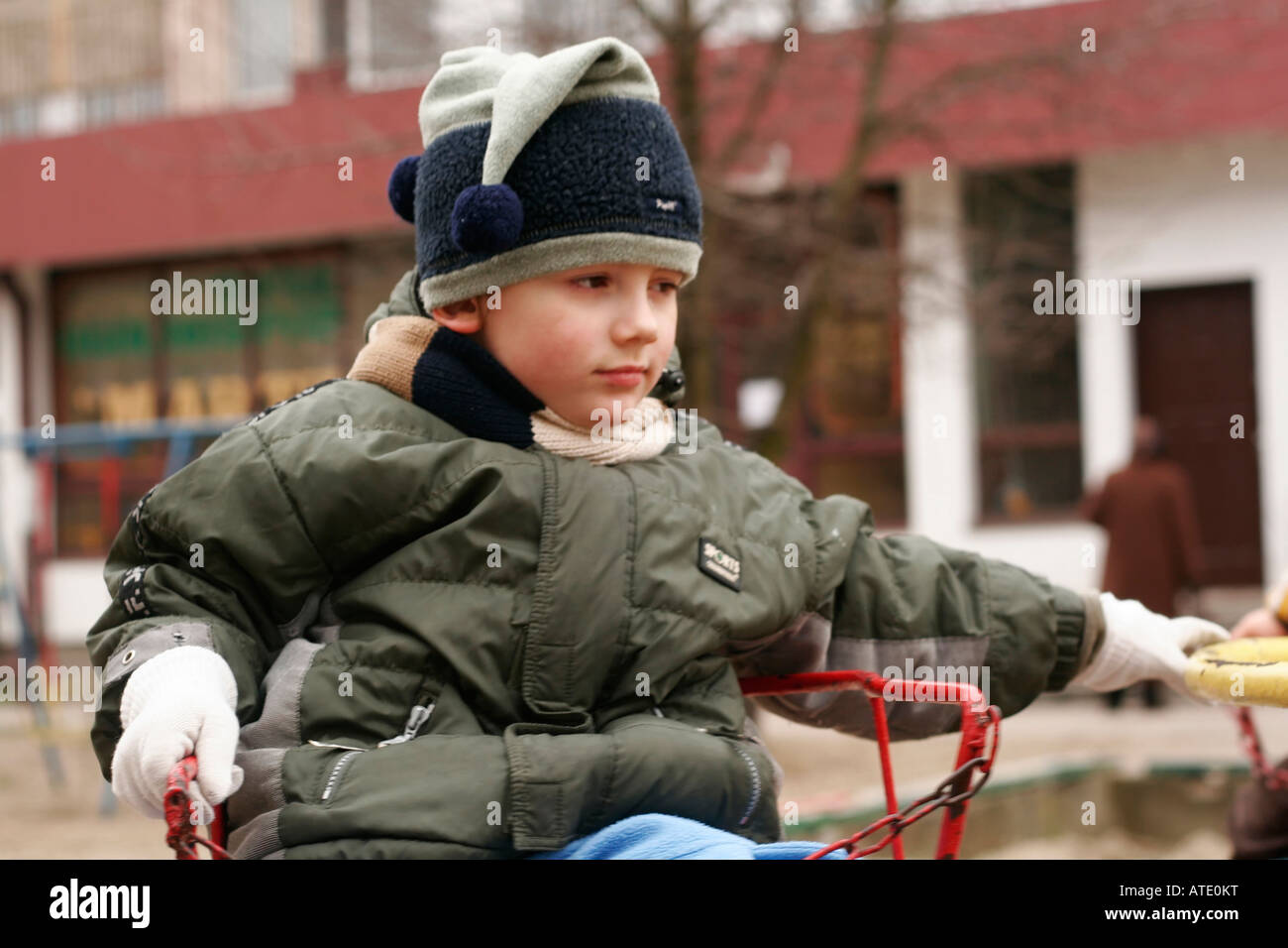 Children Playing on Merry-go-round in park Stock Photo