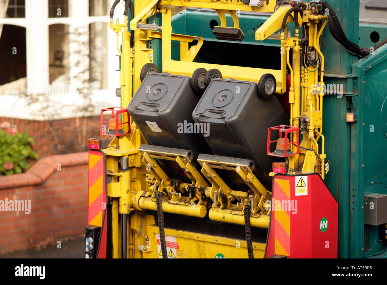 Wheelie bins being emptied into a refuse truck Stock Photo Alamy