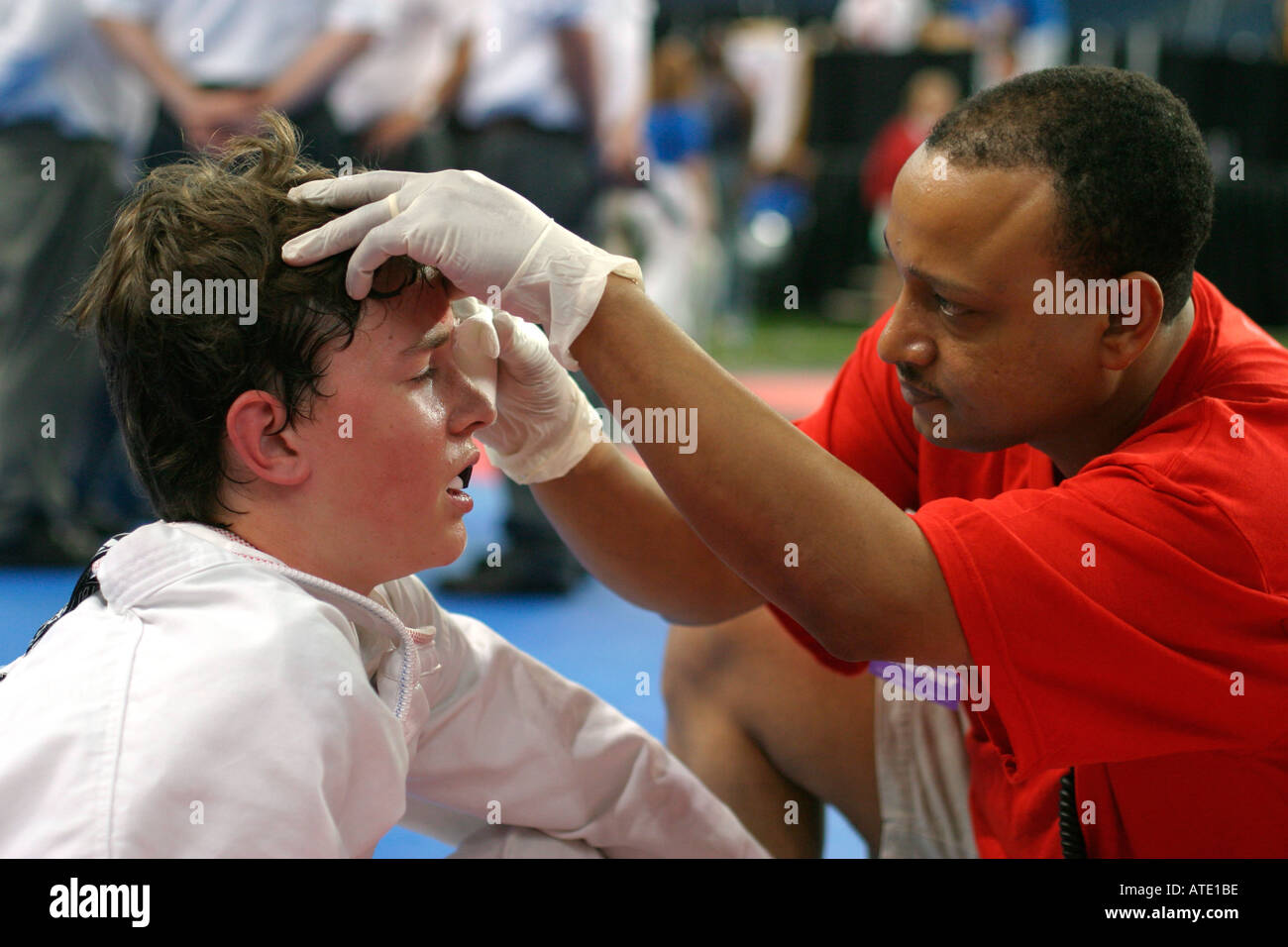 A trainer checks a boy s injury during the AAU Junior Olympics in Detroit Stock Photo