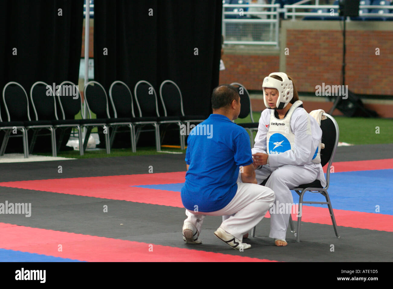 A coach talks to a participant in the taekwondo competition during the AAU Junior Olympics in Detroit Stock Photo