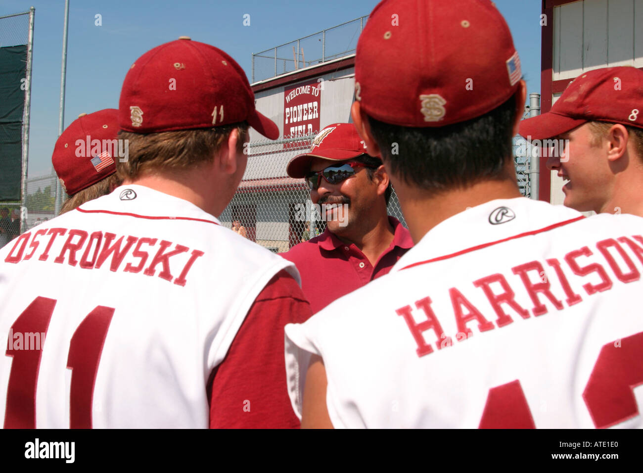 Coach talks to players before baseball competition at the AAU Junior Olympics in Detroit Stock Photo