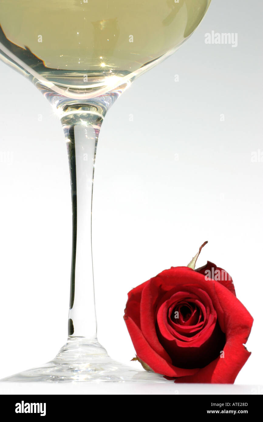 Celebration a red rose and glass of wine Stock Photo - Alamy