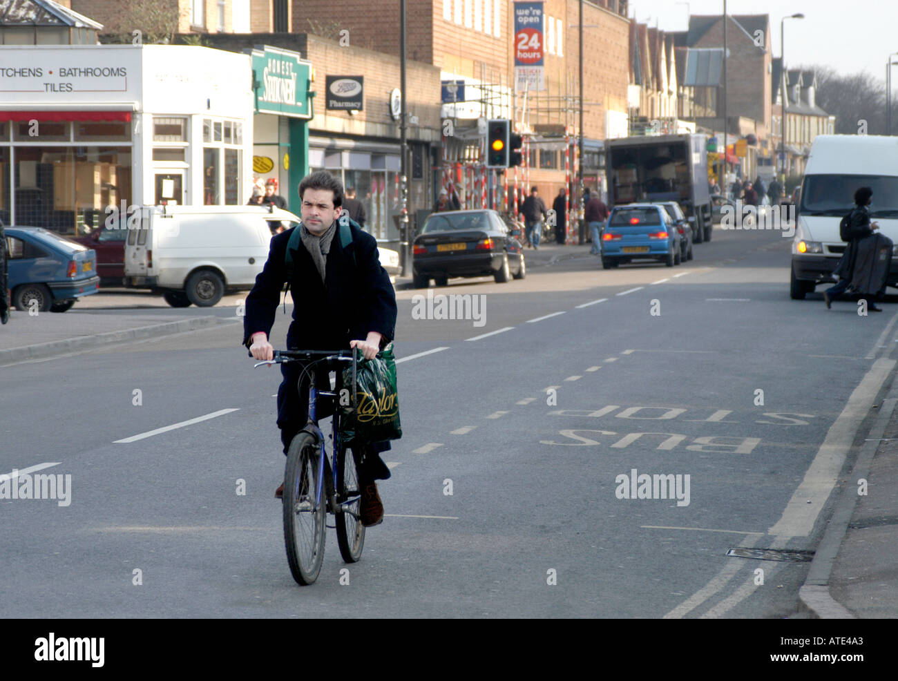 Cycling along the Cowley Road Oxford Stock Photo Alamy