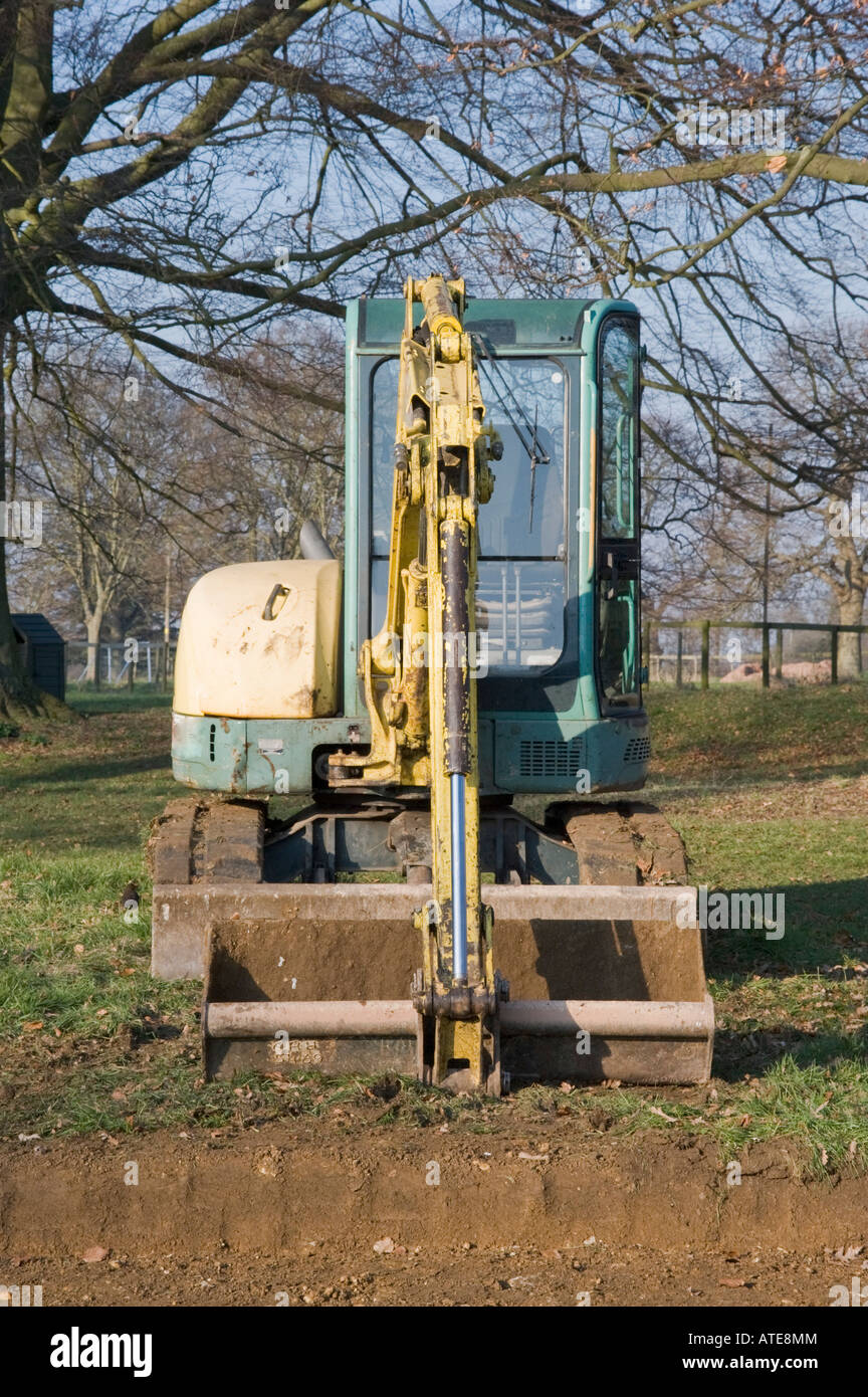 digger in countryside digging holes in the ground Stock Photo Alamy