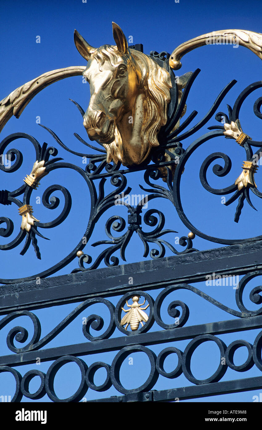 The gilded horses head set in the decorative wrought iron gateway of the Haras Du Pin Stud which