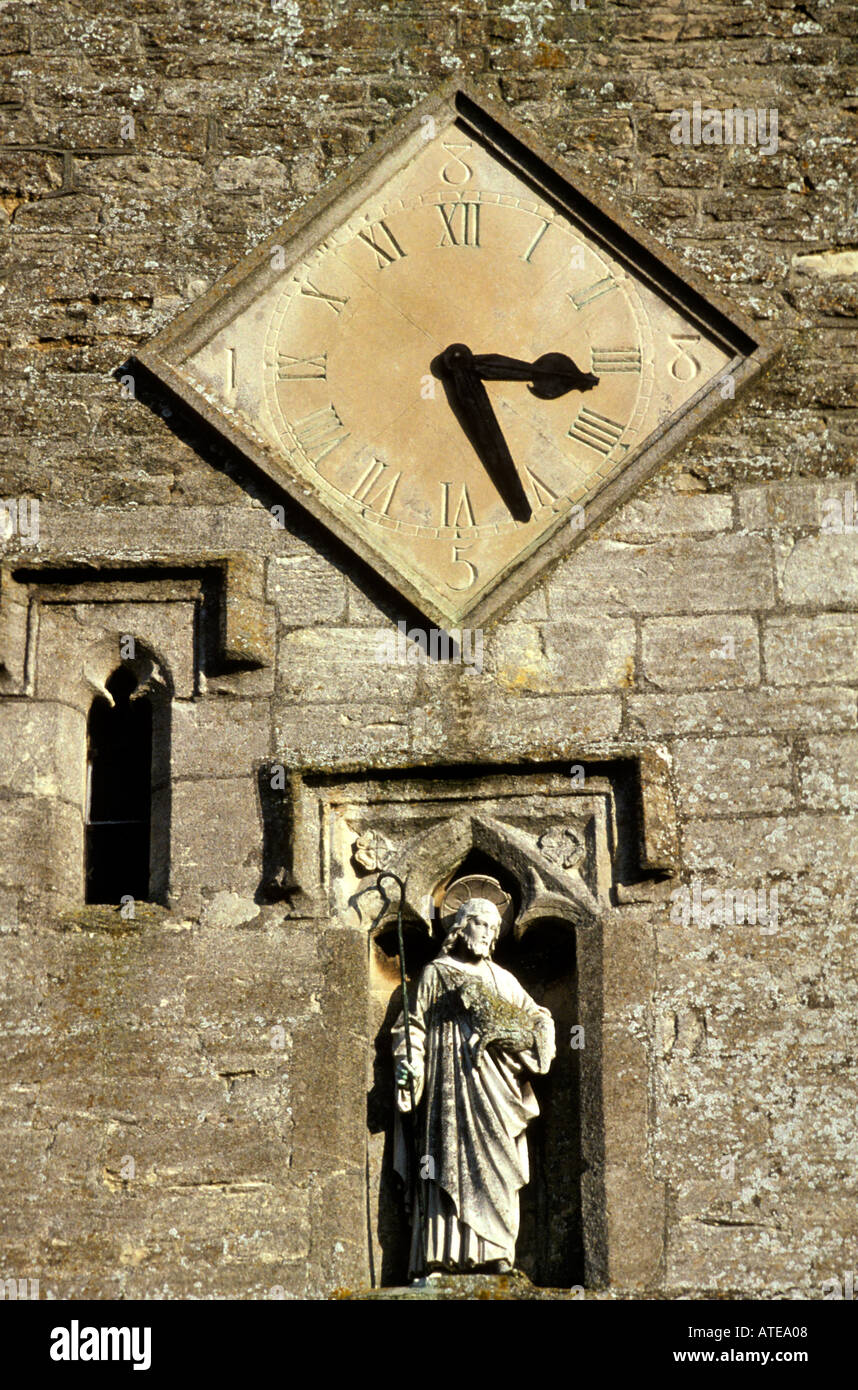 Clock face and statue on front of South Marston church Wiltshire Stock Photo
