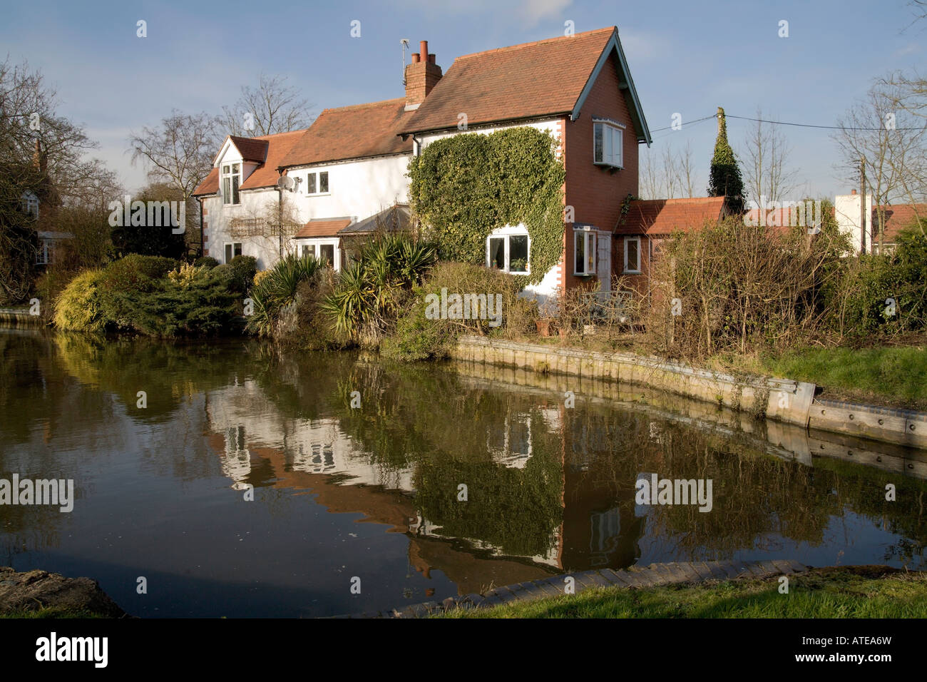 Houses next to canal or river Stock Photo - Alamy