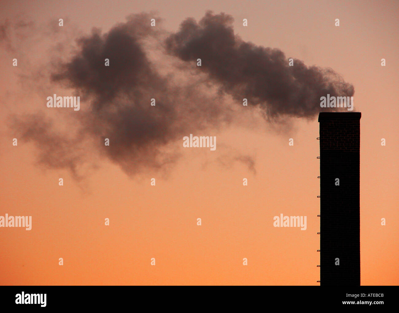 Smoke stacks and smoke during evening hours Stock Photo