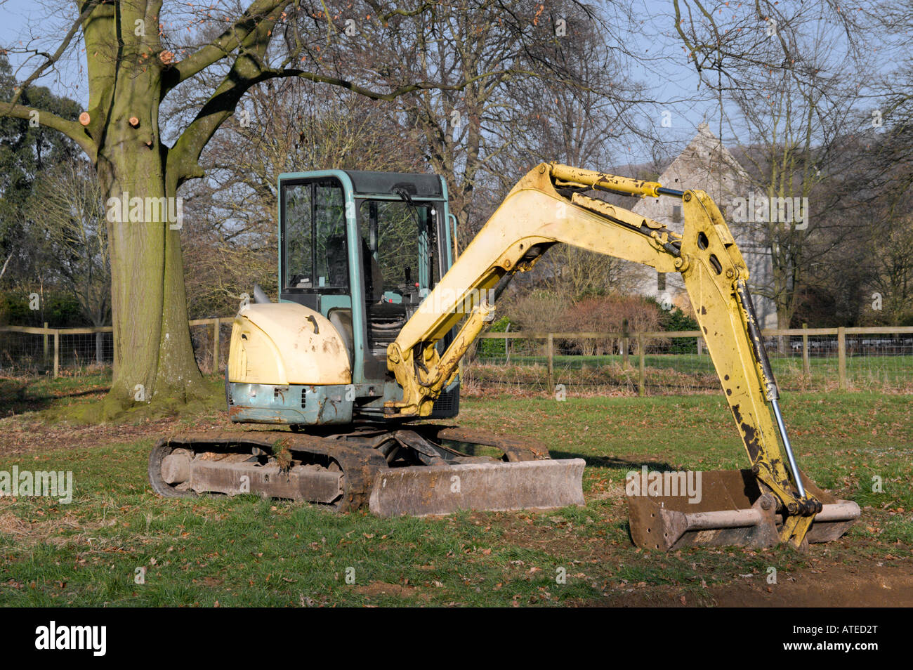 digger in countryside digging holes in the ground Stock Photo Alamy