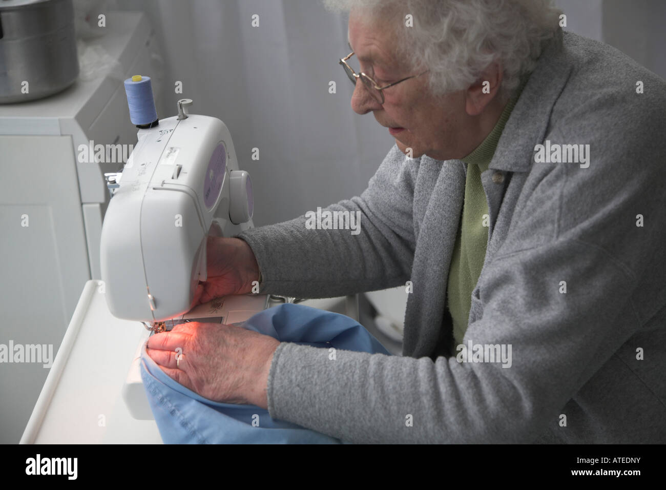 Elderly woman working at sewing machine Stock Photo Alamy