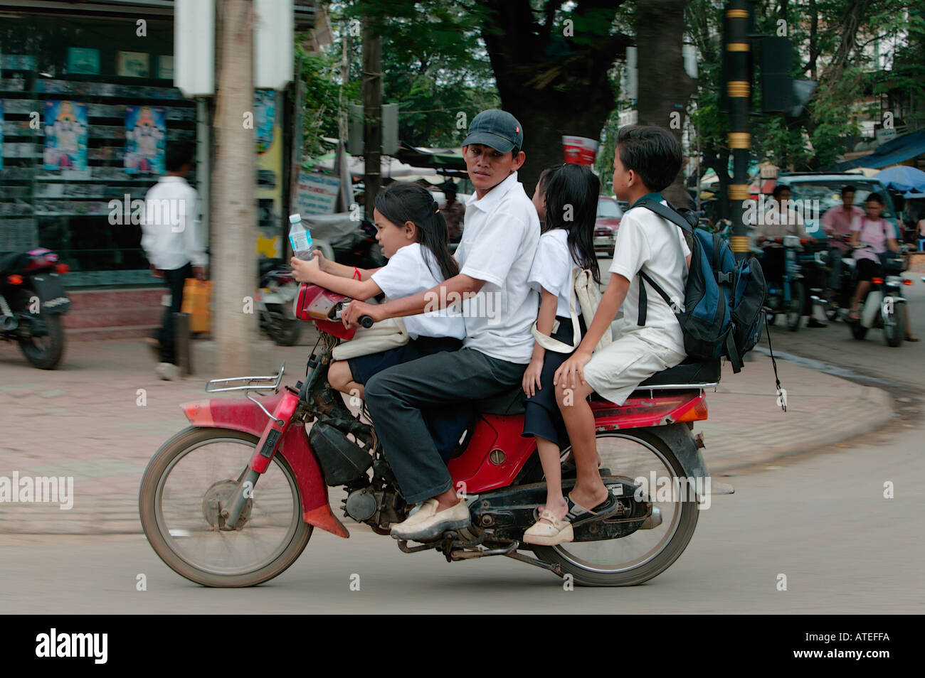 Father with kids on motorcycle in Phnom Penh Cambodia Asia Stock Photo