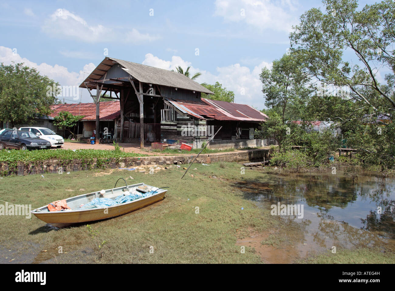 Fiber glass fishing boat moored at low tide in Pahang, Malaysia Stock